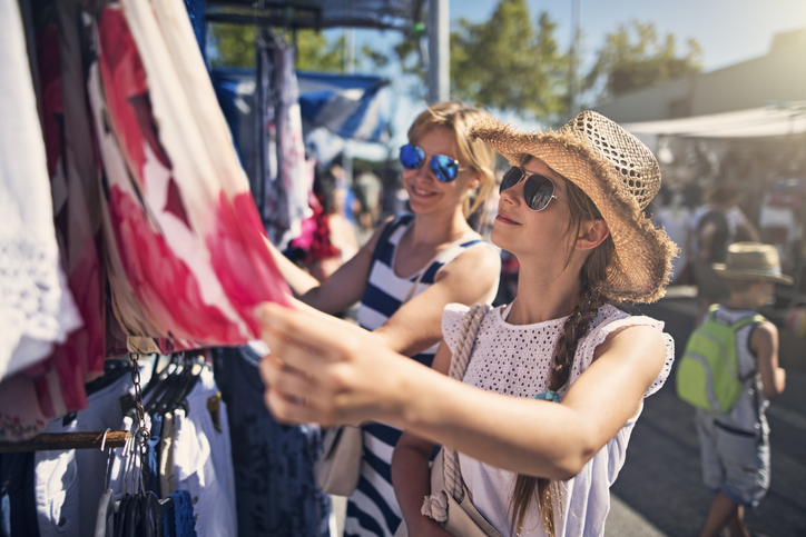 Mother and daughter buying clothes on flea market in Andalusia, Spain