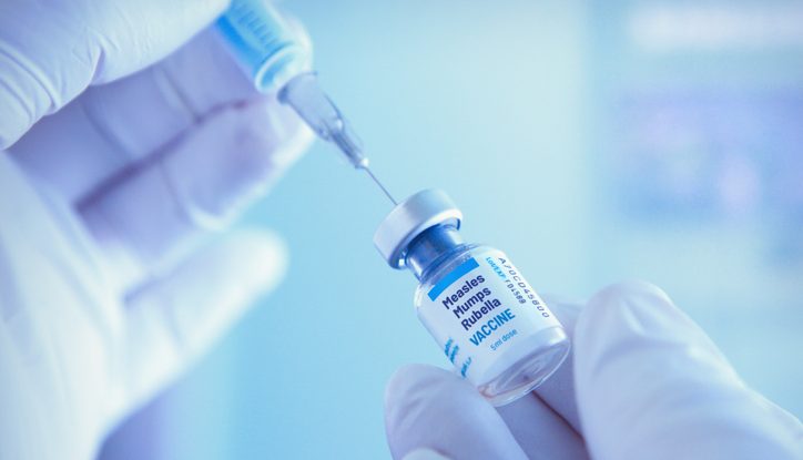 Medical worker prepareing measles, mumps and rubella vaccine for vaccination